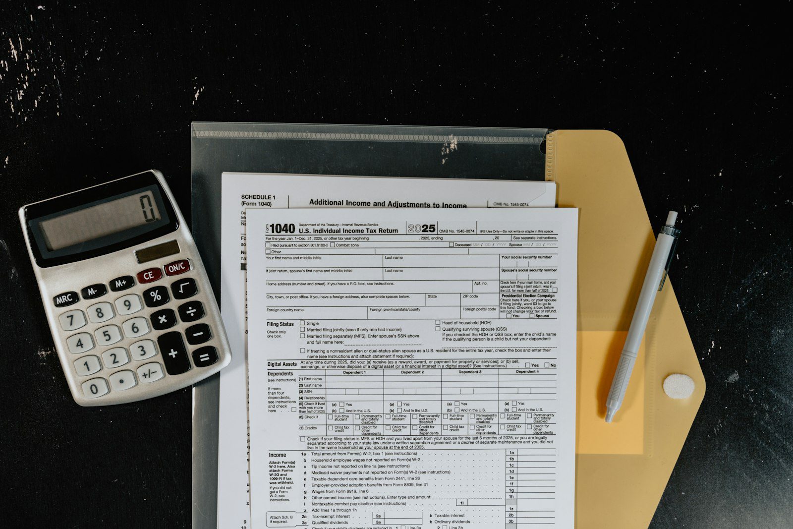 IRS letter and tax forms spilling from an envelope next to a calculator